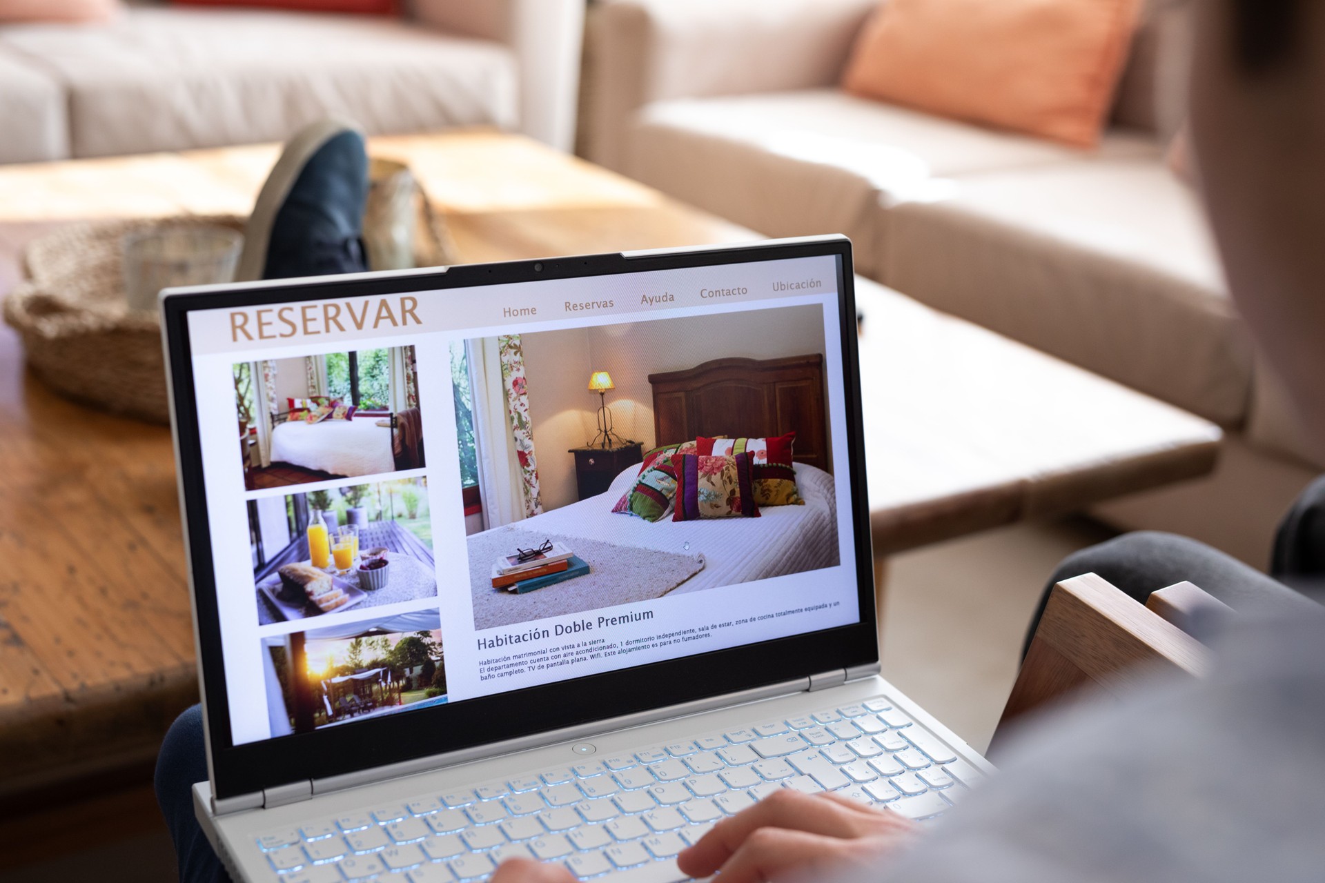 Unrecognizable person reviewing hotels online, using laptop